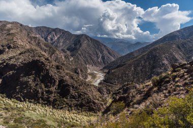 Bulutlu bir gökyüzünün altında büyüleyici bir manzara.