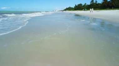 A closeup HD footage of beautiful sea waves on the Naples beach on a sunny day