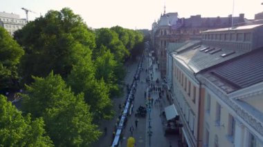 Helsinki Day city birthday event in the city, dinner with people eating in park and street