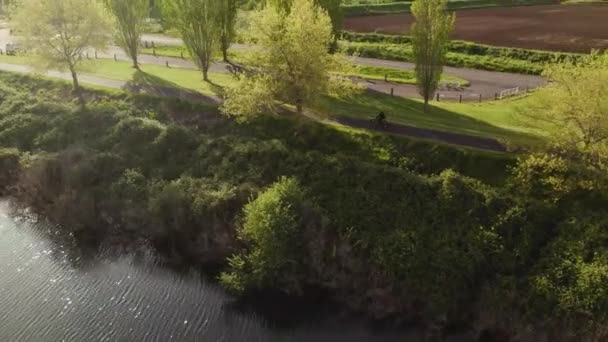 Aerial View Man Riding Bike Next Dike Sunny Day — Stockvideo