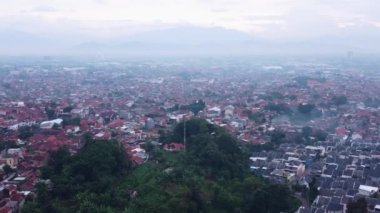 A drone view of the cityscape of Cimahi in the daytime.