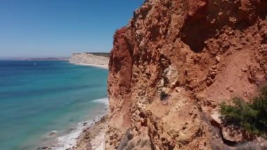 An aerial view of ocean waves splashing the rocks on Ponta da Piedade, Algarve region, Portugal