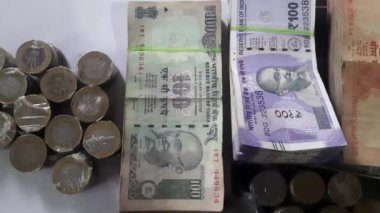A Indian rupees Indian money banknotes and coins in denominations of,20 100 200 500 India rupee money coin and banknote. Indian Currency Notes