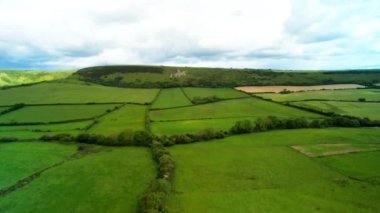 An aerial shot of green fields leading to the Osmington White Horse in Osmington Hill, Weymouth, Dorset