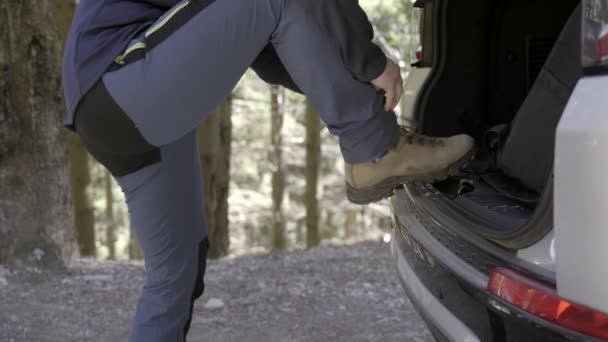Person Tying Shoes Car Trunk Forest — Stok video