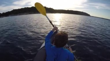 A high angle view of a caucasian woman kayaking on a lake