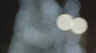 The blurry lights changing to lights from Christmas trees