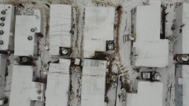 A mobile home park at wintertime with people walking around