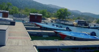 A view of boats parked in a harbor in the daytime in the lake.