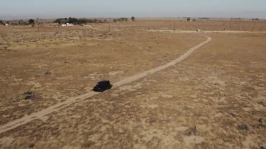 A beautiful view of a car in a desert in a daylight