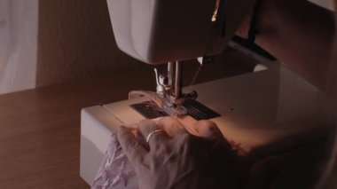 Female worker adjust sewing machine
