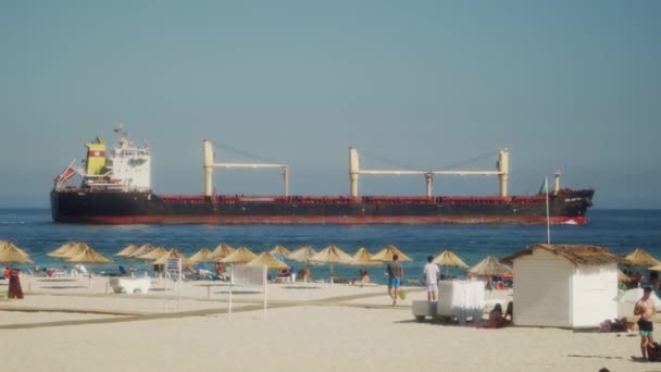 Large Cargo Ship Cruising Away Beach Clear Cloudless Sky — Stock Video