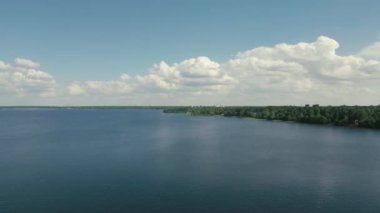 A scenic view of the sea on a sunny day with clouds