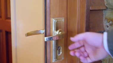 A faceless businessman in a formal outfit opening the door and entering a meeting