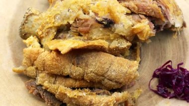 A closeup of crispy pork rinds rotating on a lazy Susan