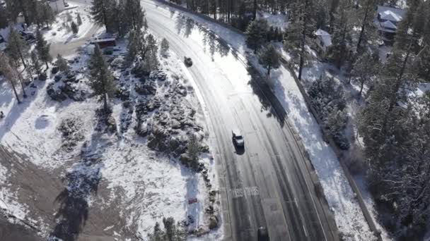 Drone Shot Cars Driving Road Snowy Houses Leafless Trees Winter — Wideo stockowe