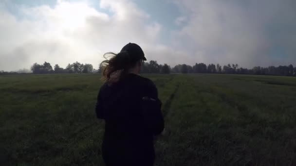 Back Shot Young Female Black Sportive Outfit Running Green Field — Video Stock