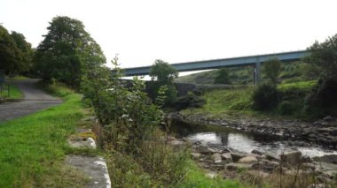 A modern road bridge passing over the traditional stone bridge, Dunbeath Strath, Scottish Highland