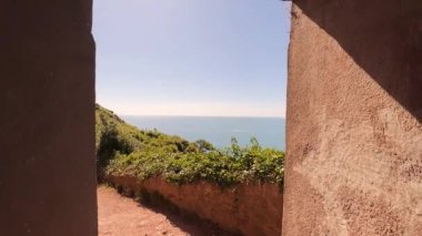 A beautiful view of the beach from the door of the old building, England, UK