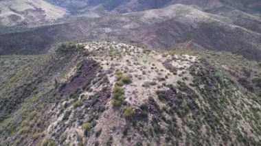 An aerial slow movement around greenery mountains