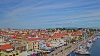 An aerial footage of a town with a beautiful port and residential buildings in a daylight