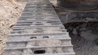 A Close-up of continuous or caterpillar track of heavy construction equipment vehicle or machine. Detail, part, or propulsion system of modern tracked