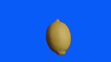 A slow motion of a yellow lemon isolated on the blue background