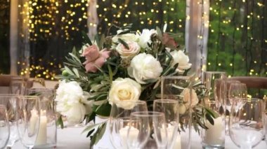 A close-up view of bridal flowers and a decorated table set ready for the party.