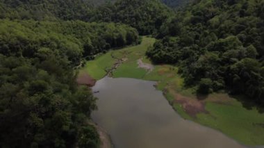 An aerial view of a valley and a lake in Chiang Mai, Thailand in HD