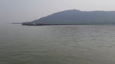 The tourist ferry boat is reaching Elephanta Island Harbor Port in India - Gateway Of India To Elephanta Caves
