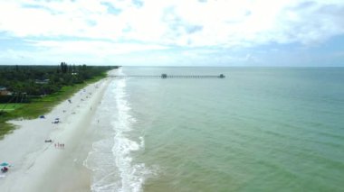 A beautiful high angle drone footage of the Naples beach on a sunny day