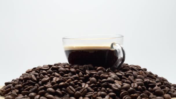 Closeup Rotating Cup Coffee Pile Coffee Beans White Background — Vídeo de Stock