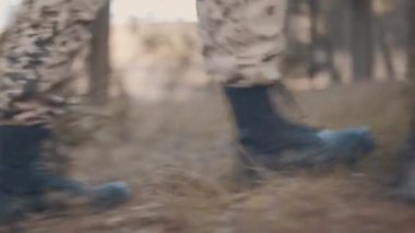 cup of tea in male hands by the campfire in autumn forest
