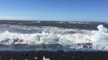 Seafront of the Iceland with pieces of glacier on the beach