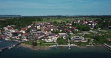 A drone shot over the small touristic town Gstadt am Chiemsee in Bavaria by the sea