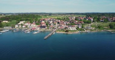 A drone shot over the small touristic town Gstadt am Chiemsee in Bavaria by the sea