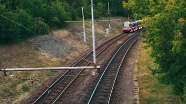 A high-angle shot of a tram passing by in slow motion.