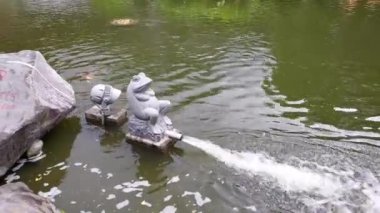 Frog-shaped fountain on shore of pond at Chiang Kai-shek Memorial Hall in Taipei, Taiwan