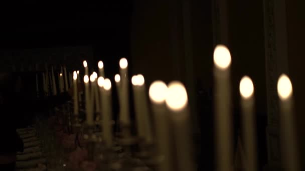 Rows Burning Candles Dark Church Bokeh Background — Stock Video