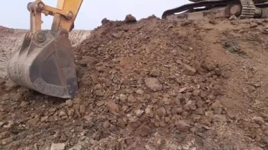 A Excavator at work. Mechanical shovel working on the field at dawn.