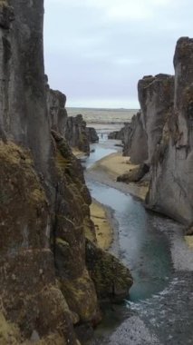 An aerial view of a valley and a river in Iceland