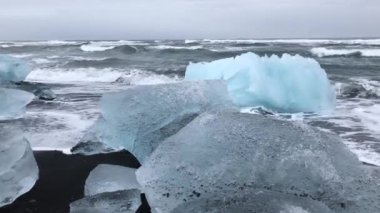 Seafront of the Iceland with pieces of glacier on the beach