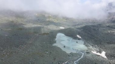 A beautiful view of a glacial lake in the alps on a cloudy day