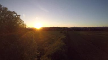 A beautiful view of a sunrise over green agricultural field