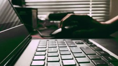 A closeup of a hand typing on a laptop