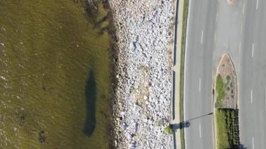 A top view of a road by the lake
