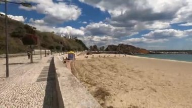 A timelapse walkway on a path near a beach on a cloudy day.