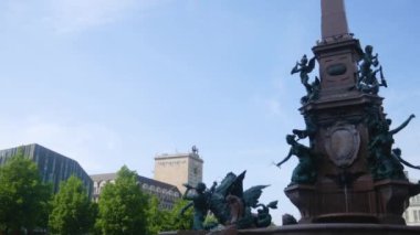 A beautiful view of Mendebrunnen fountains against a blue sky