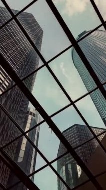 A low angle shot of skyscrapers from a glass in Detroit, United States
