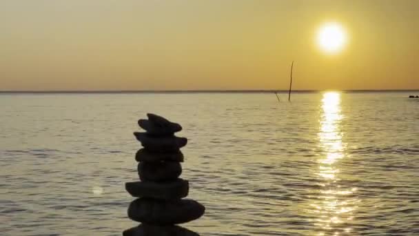 Stones Stacked Top Each Other Beach Calm Waves Scenic Sunset — Stock Video